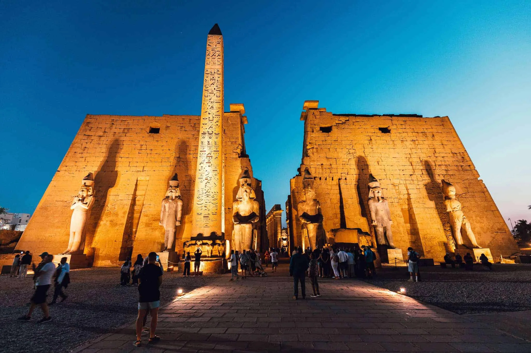 The lit entrance pylon of Luxor Temple at night