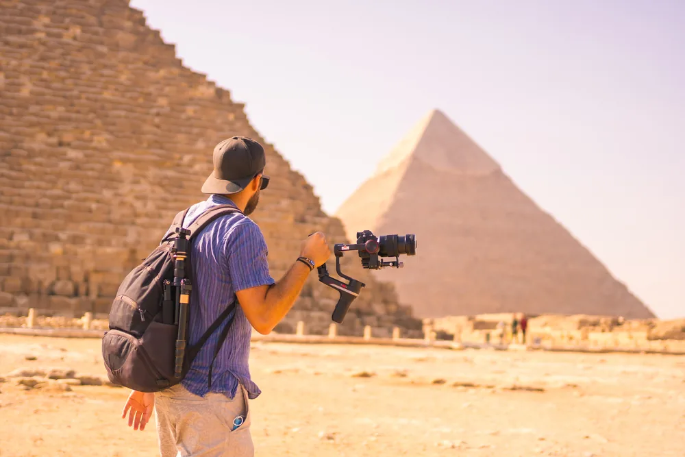 Tour guide speaking with tourists carrying cameras